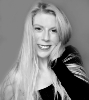 Professional headshot of Savannah Muncy, PharmD, smiling with her chin resting on her hand, long straight blonde hair flowing over one shoulder, wearing a dark long-sleeved top against a neutral studio background, in black and white